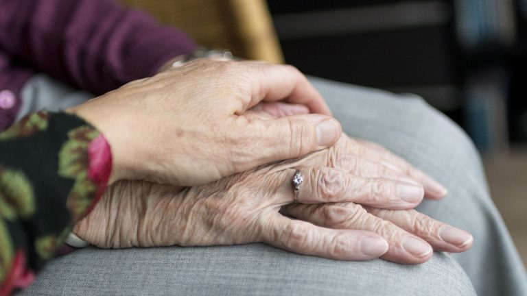 A woman holding the hand of a woman